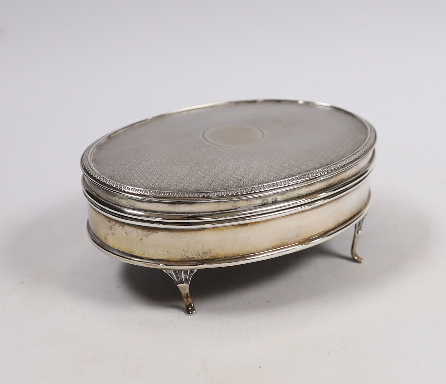 A George V part engine turned silver oval trinket box, Walker & Hall, Birmingham, 1921, 12.8cm.